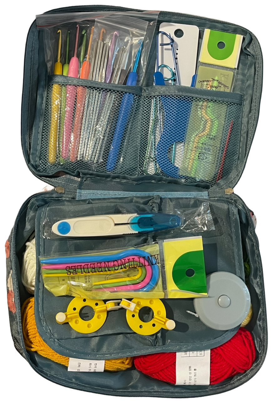 Open crochet knitting kit with various tools and materials on a white background