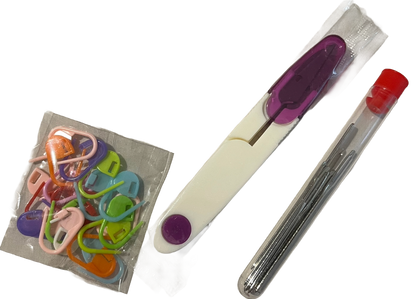 Set of colorful sewing needles and a purple cutting tool colorful stitch markers on a white background