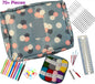 Crochet kit with floral-patterned pouch, yarn, hooks, and tools on a white background