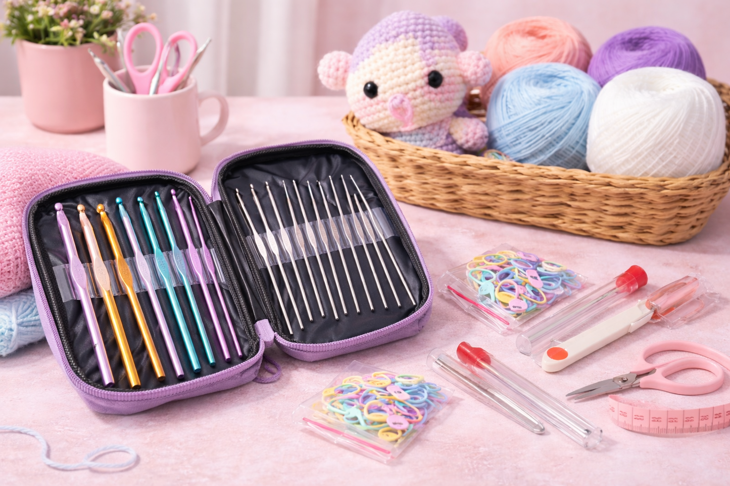 Crochet Hook and needles set in a purple case with yarn and knitting tools on a pink surface
