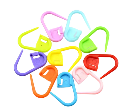 Colorful plastic stitch holders markers for crochet hooks on a white background
