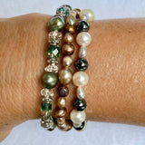 green bronze grey pearl bracelets on arm